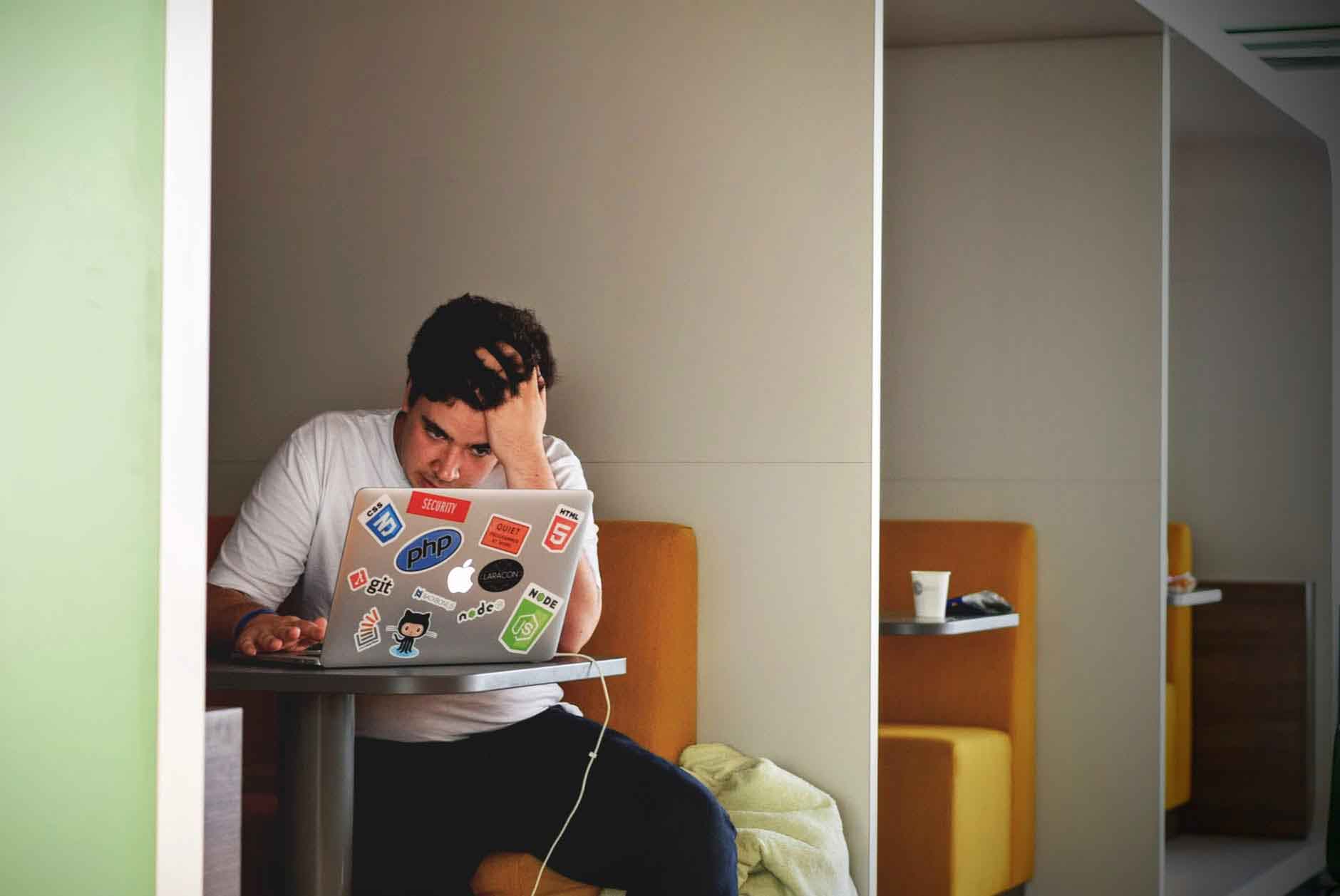 Compressed-what-to-ask-tx-center male college student at laptop wonders what to ask at tx center