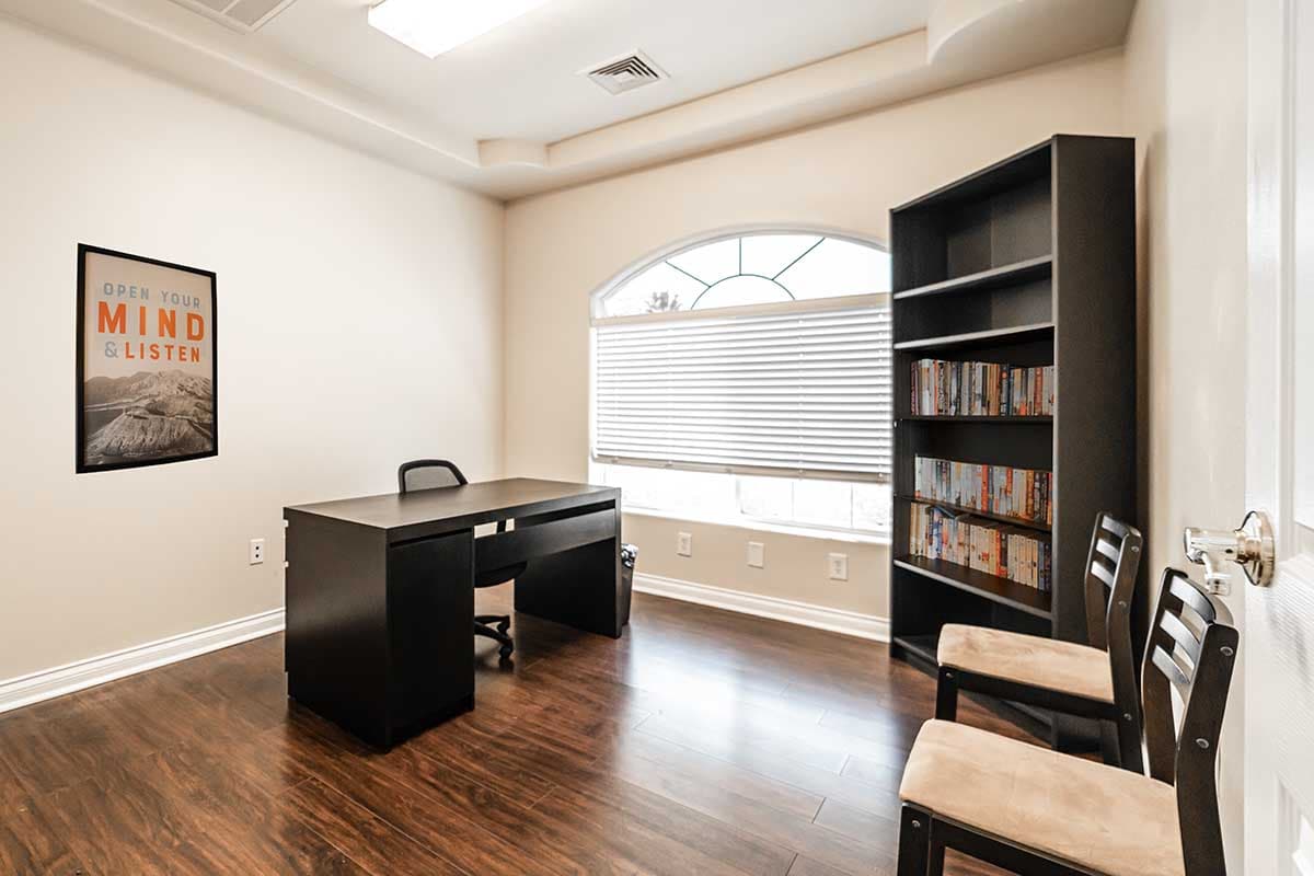 room with desk bookshelves and chairs at nevada addiction rehab center