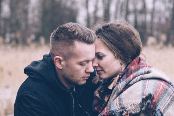 young fall couple embracing in the woods illustrating how addiction affects the people around you