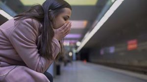 woman hunched over waiting for a train, anxiety treatment center az