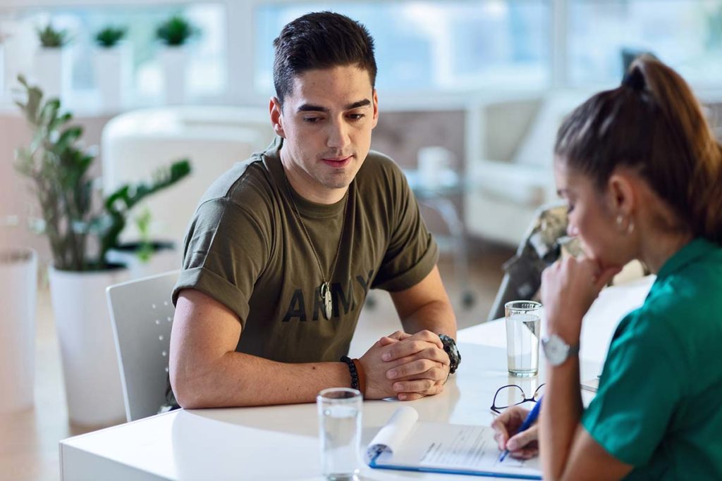 military man and nurse talking about veterans and addiction