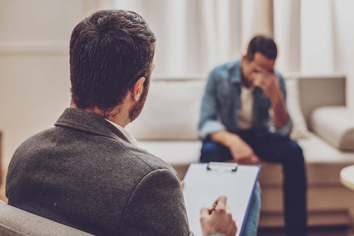 despairing man with therapist discussing what is interpersonal therapy