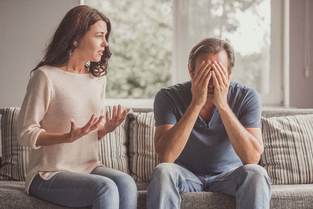 woman arguing with man because dating an alcoholic is difficult