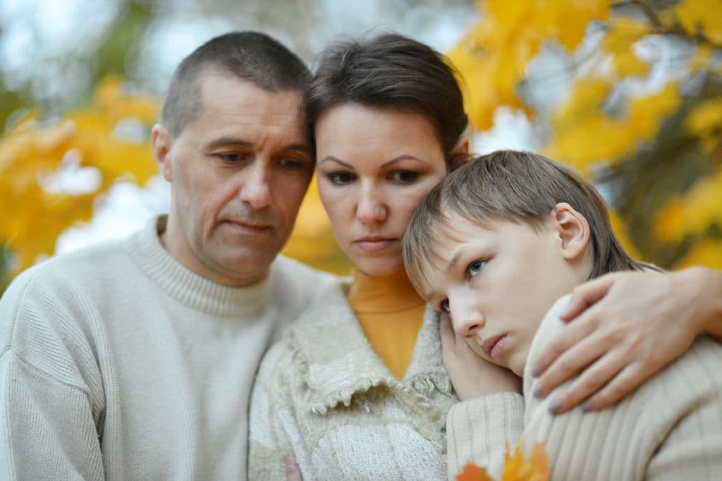 pensive mother father and son all too aware of how addiction affects families