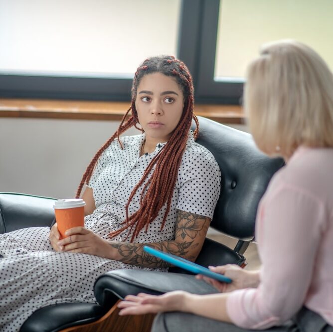 woman talking to therapist in rehab about What is a Dry Drunk
